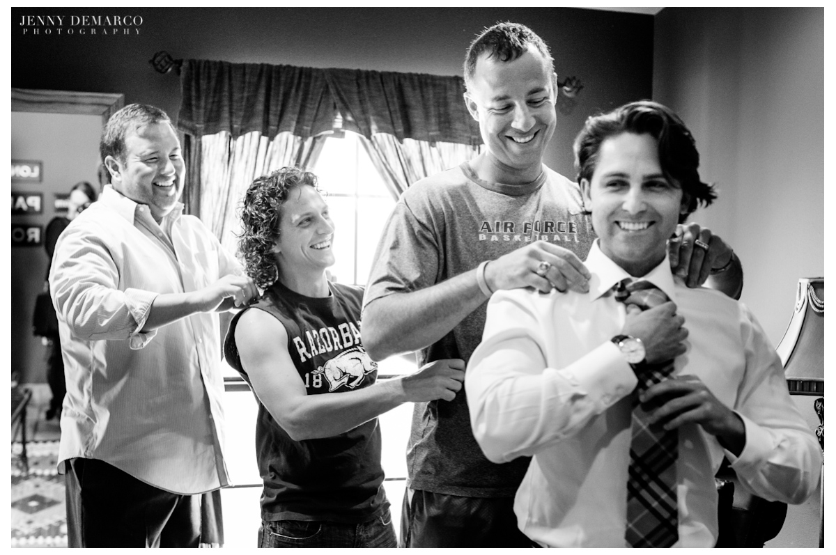 The groomsmen having fun before the wedding and giving the groom a massage.