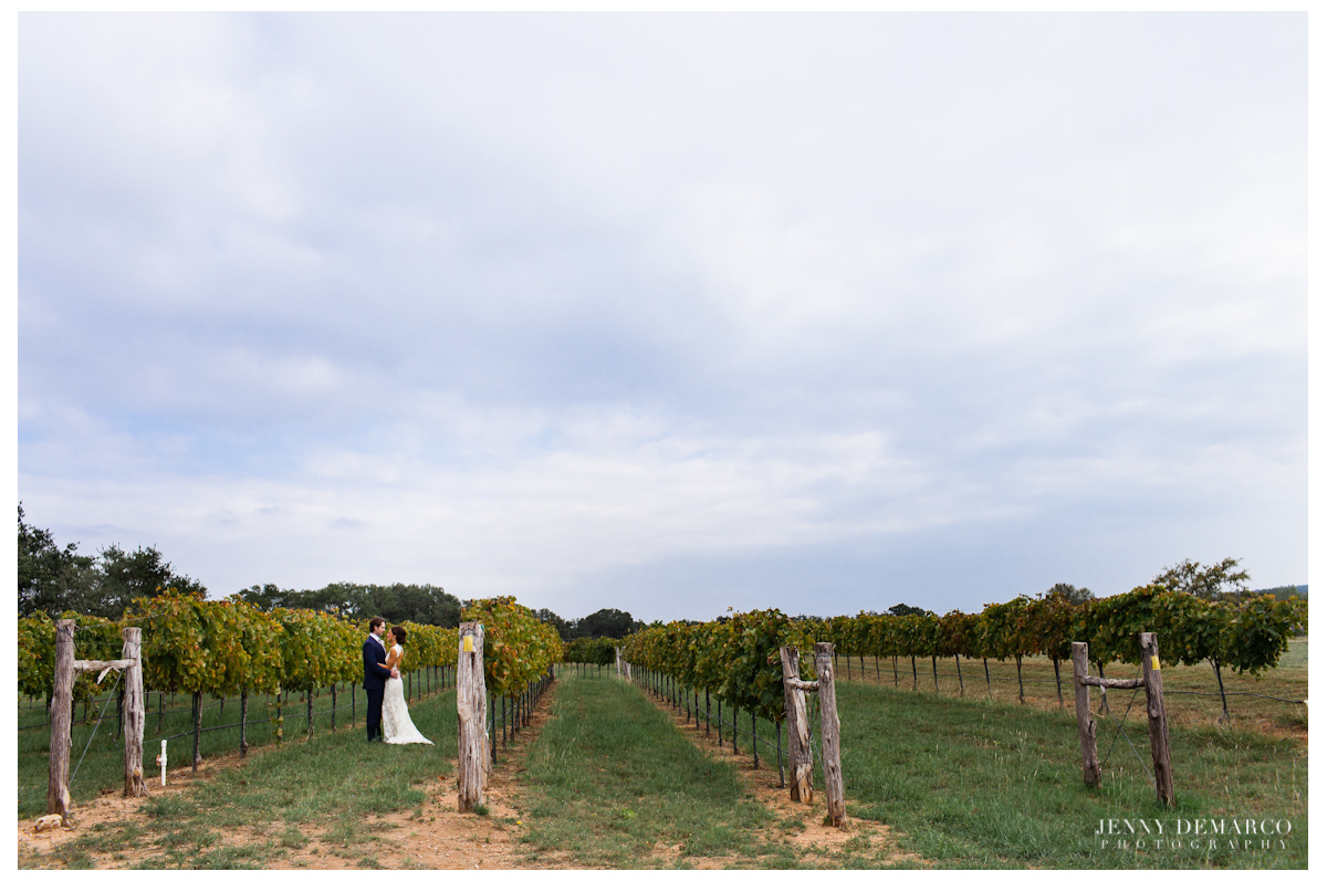 The bride and groom in the Texas hillcountry vineyard.