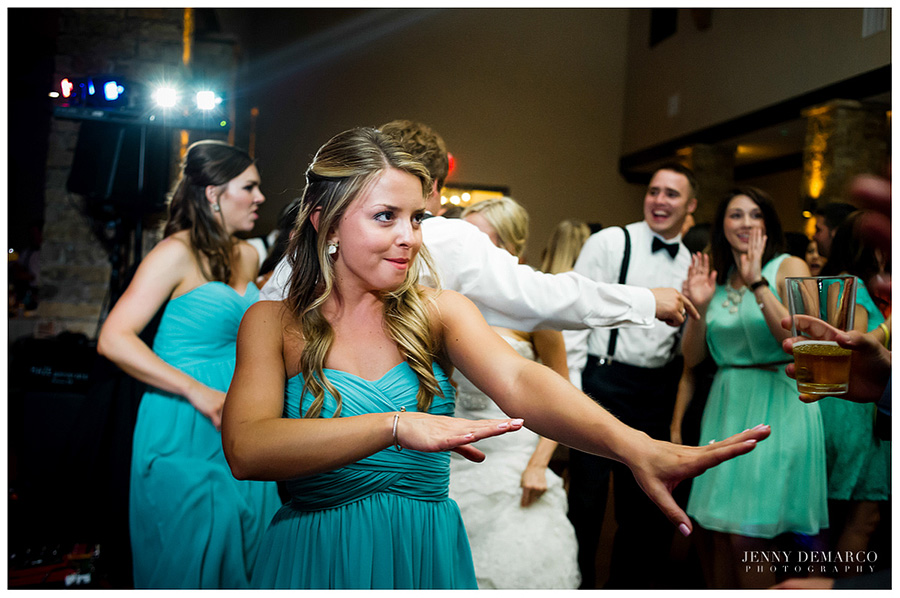 A bridesmaid dances at the wedding reception.