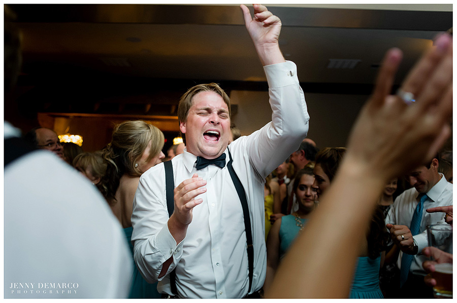 One of the groomsmen dances at the reception in the Members Lodge.