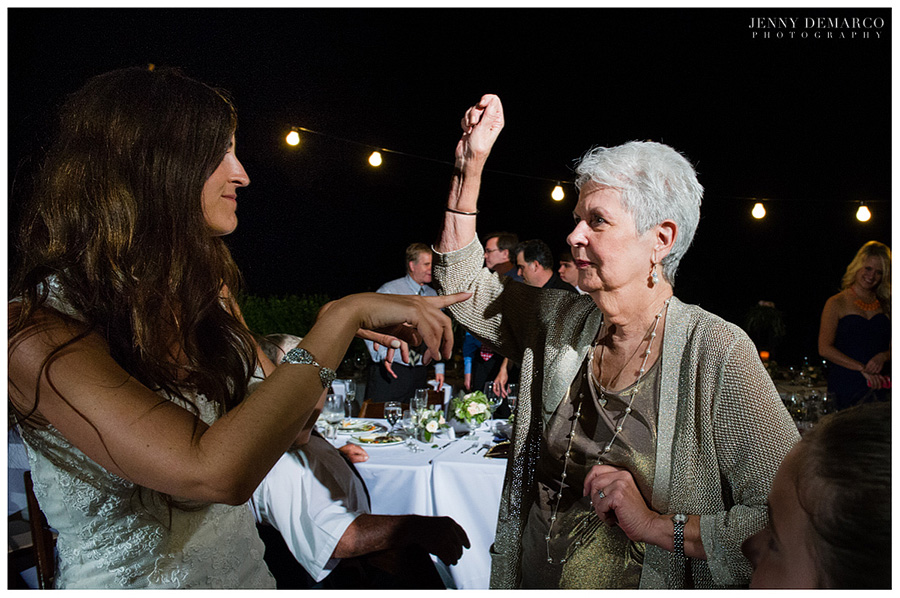 The bride and grandmother dancing to the music at the wedding reception. 