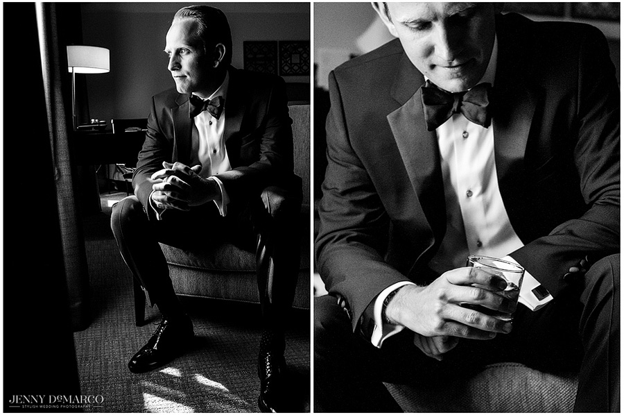 Sam posing for a GQ style groom portrait in his black tie tuxedo with a glass of scotch