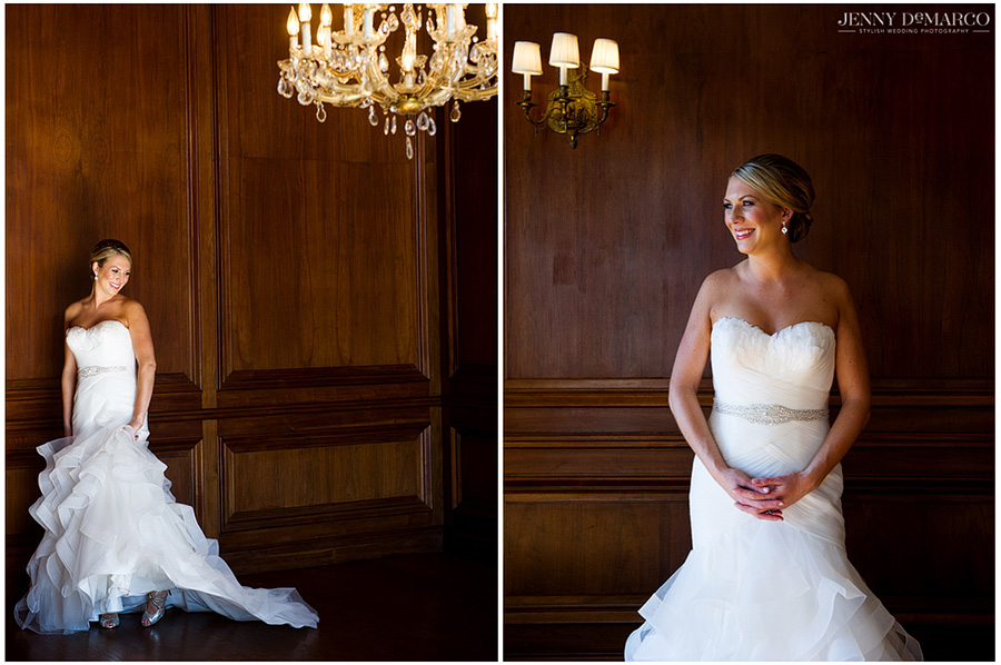 Bride posing in the cozy walnut-paneled library underneath the golden chandelier.