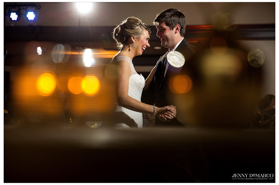 Bride and Groom look happily into each other's eyes during their beautiful Ridgewood Country Club wedding reception.