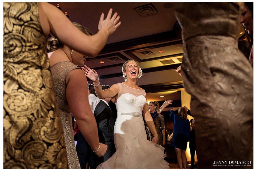 Bride laughing and smiling during wedding reception.