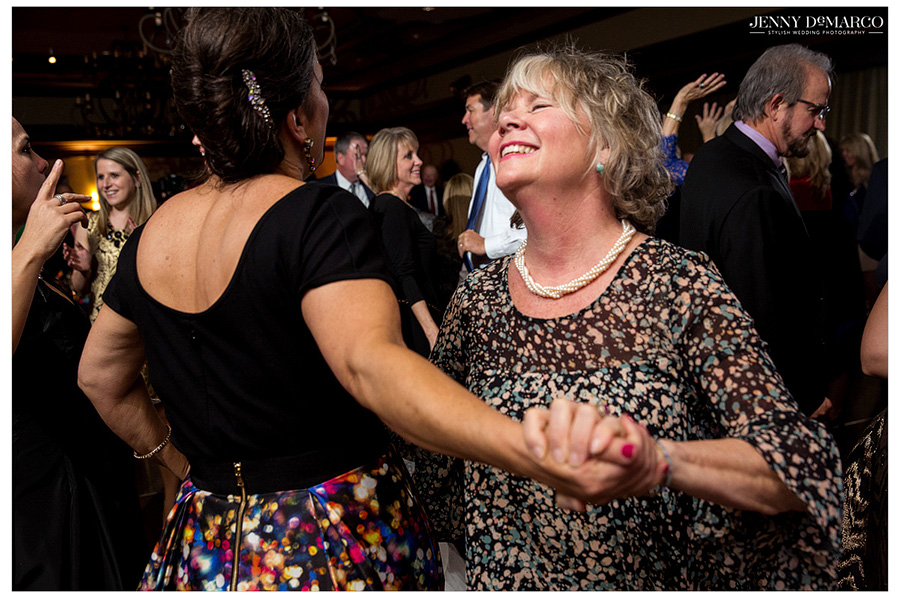 Smiling and dancing guest at wedding reception in Waco, Texas.