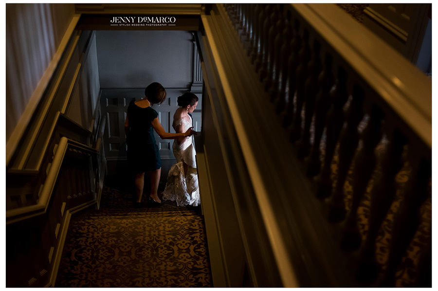 Unique overhead shot of bride and her mother walking down the steps, on the way to the aisle. 