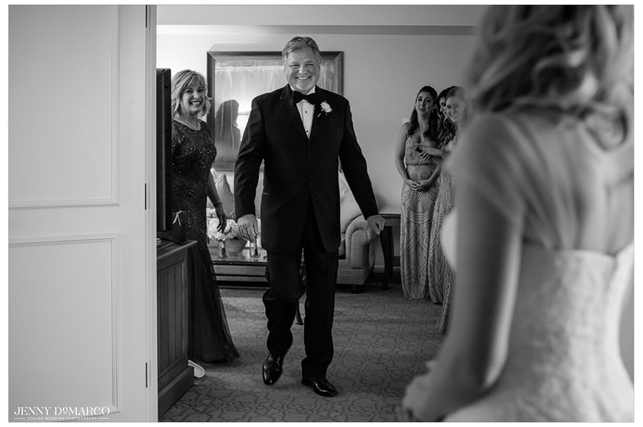 The father of the bride cannot hide his emotion as he sees his daughter for the first time.