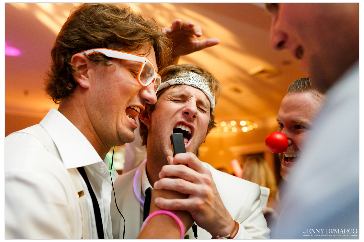 The groom grabs the mic as he and his friends celebrate during the last few moments of the reception.