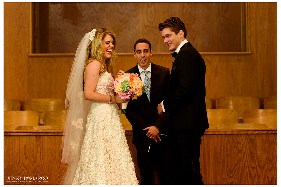 Photo of the smiling bride and groom at the altar.