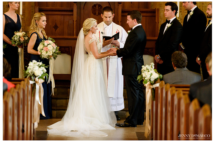The bride and groom stand at the altar of Central Christian Church as the minister leads the wedding ceremony.