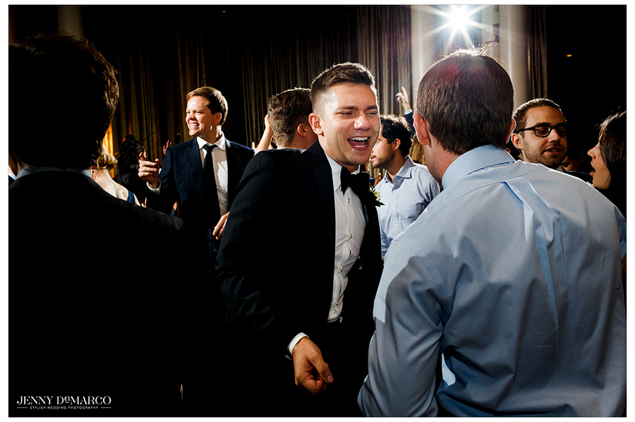 Guests dance and mingle at the wedding reception. 
