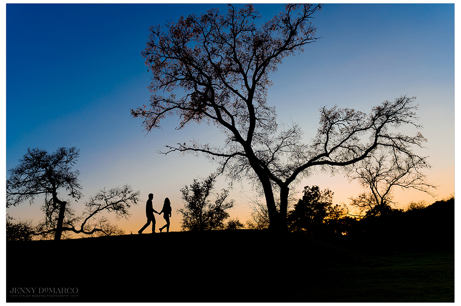 A silhouette of the couple with a beautiful sunset background as the walk along an Austin Texas trail