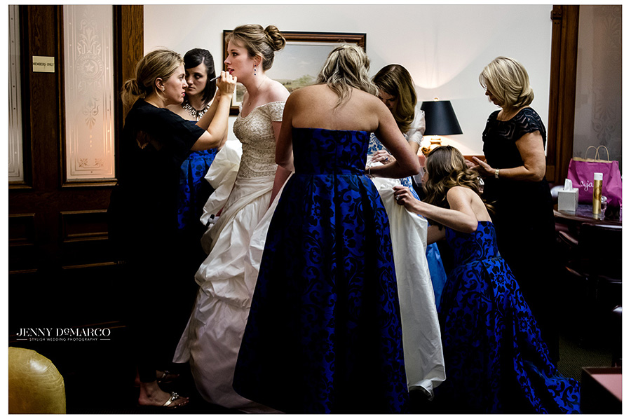 Friends and mother finish prepping bride Catherine with a few finishing touches. 