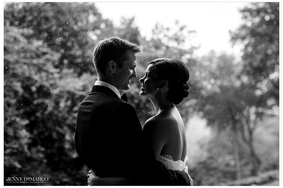 black and white side profile view photo of bride and groom embracing