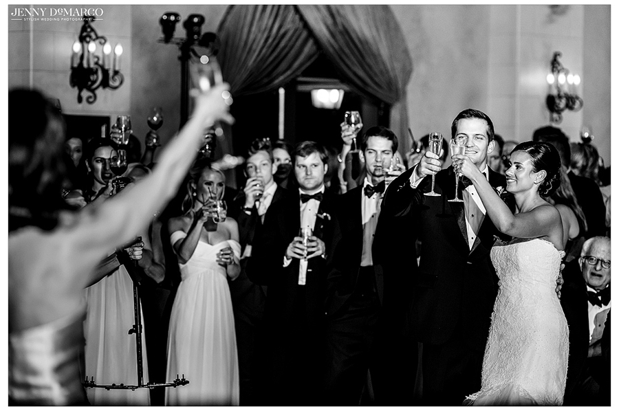 Wedding guests cheers and smile after toast is given 