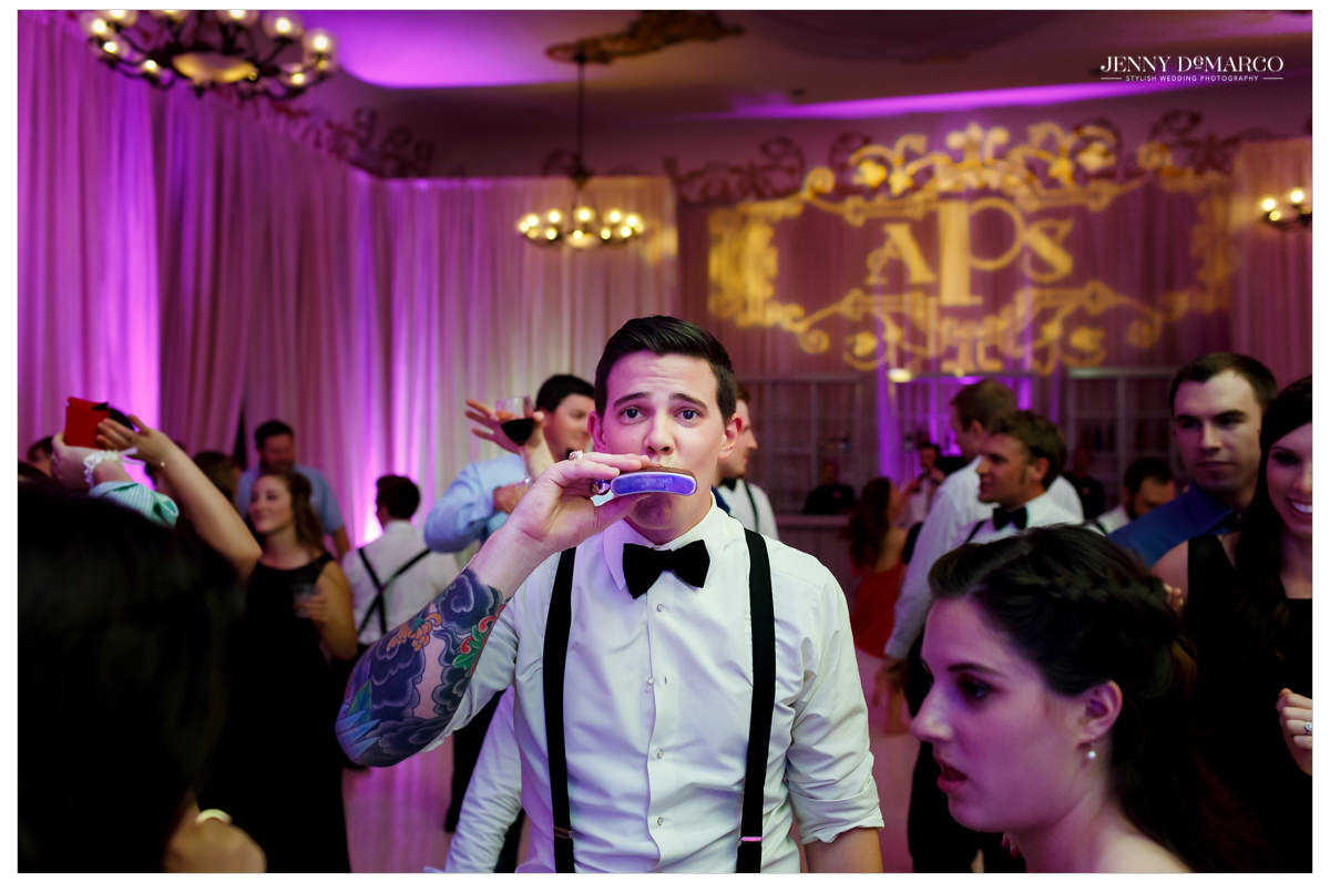 The groom with a flask, bow tie, and suspenders.