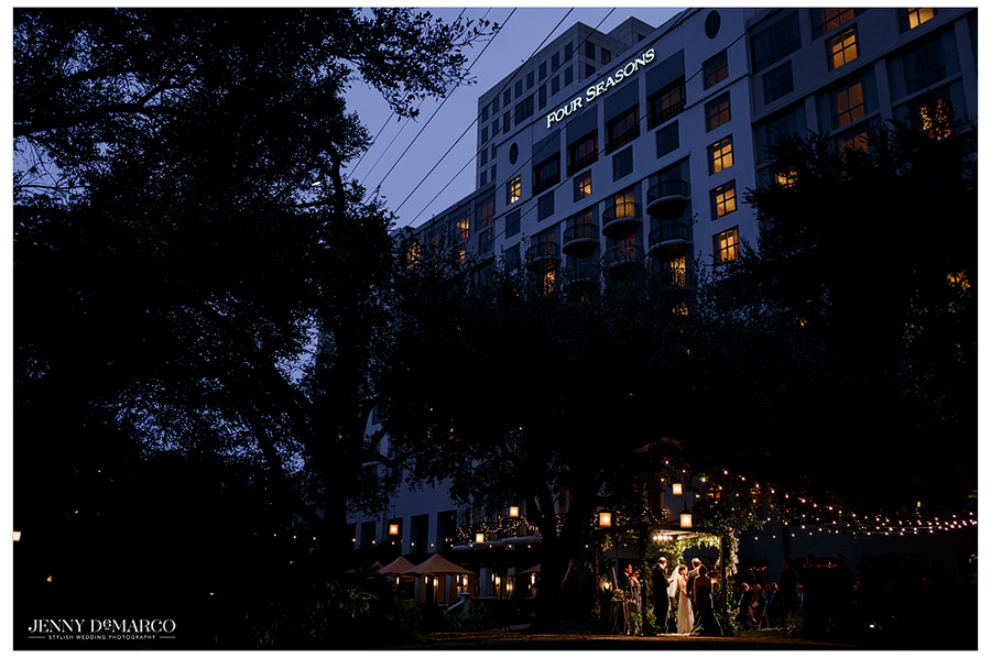 A shot of the wedding in front of the beautifully decorated Four Season's hotel.