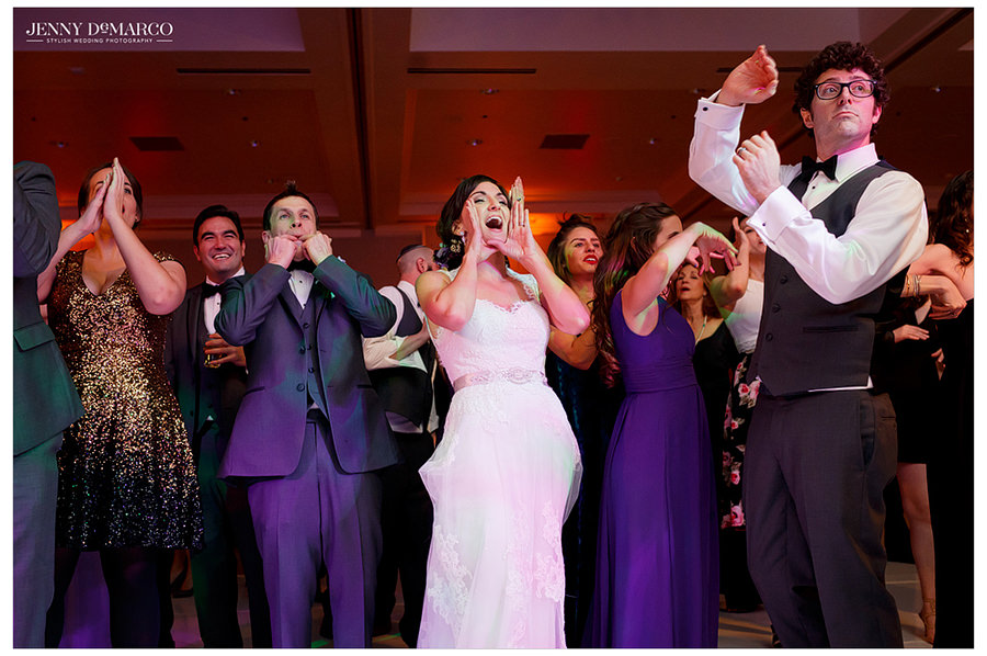 The bride and groom and their guests cheer on the band as they perform.