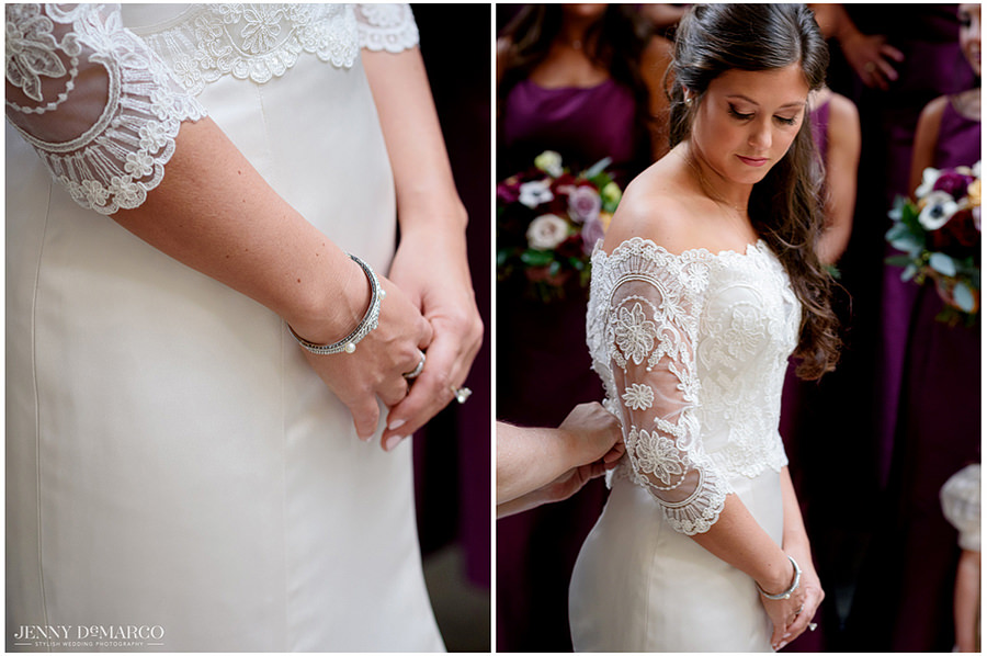 Bride putting the last finishing touches on her dress before walking down the aisle. Close up shot of lace on her sleeve and jewelry details.