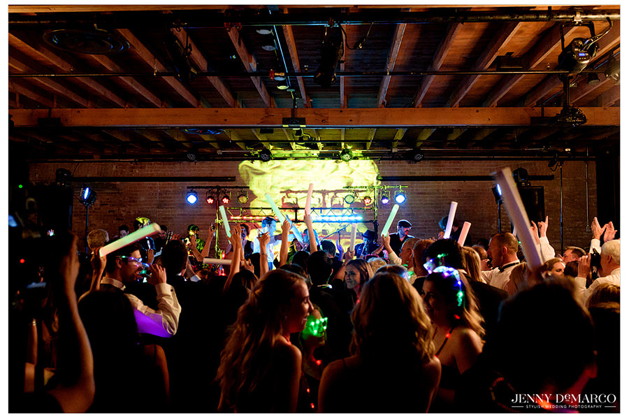 Guest partying with glow sticks at the reception.