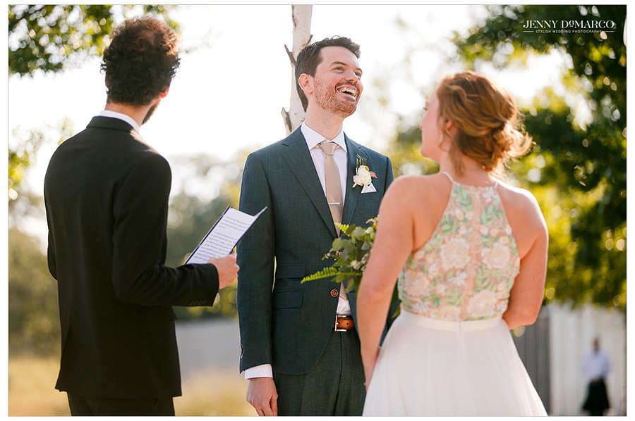 Groom laughing during the wedding vows