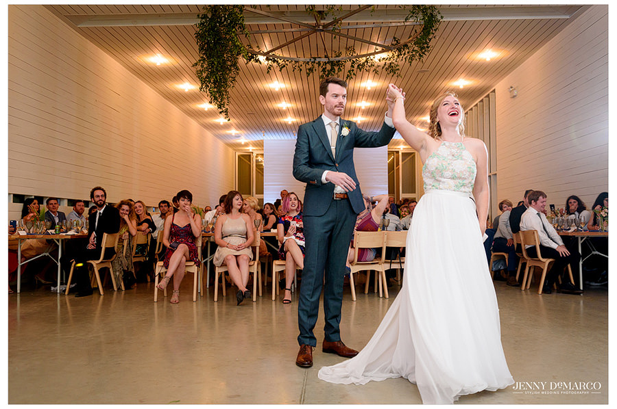 Groom twirls bride during their first dance