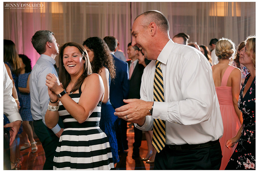the bridal party dances with guests at the historic venue
