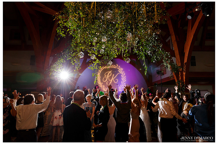 the newlyweds light logo on the stage to show al the guests