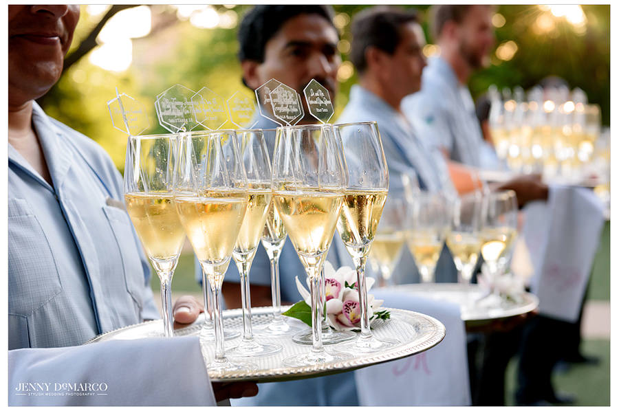 A multitude of champagne filled glasses await the guests.