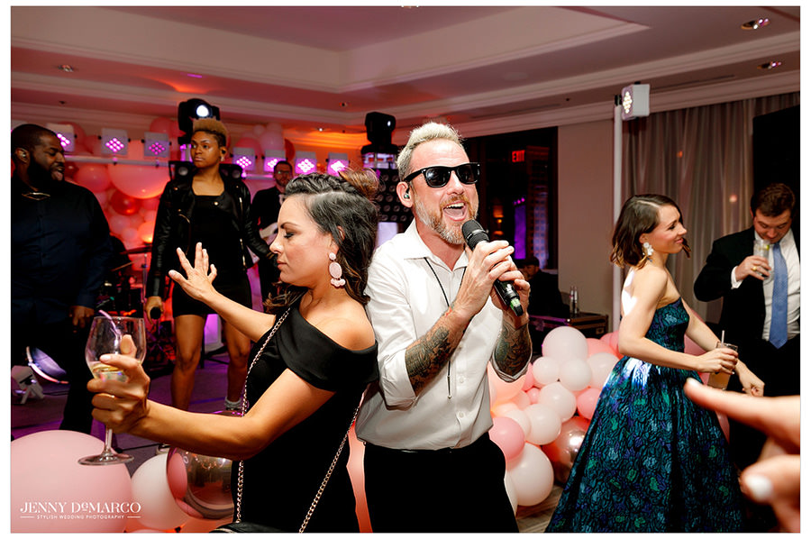The band gets the party started by singing with guests on the dance floor.