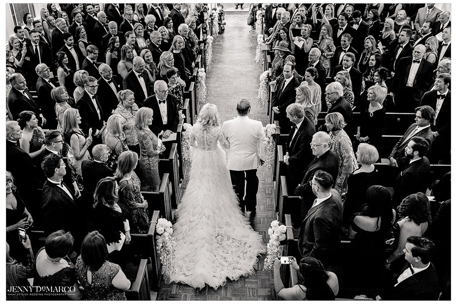 Sheridan walks down the aisle towards Tyler with her arm in her dads.