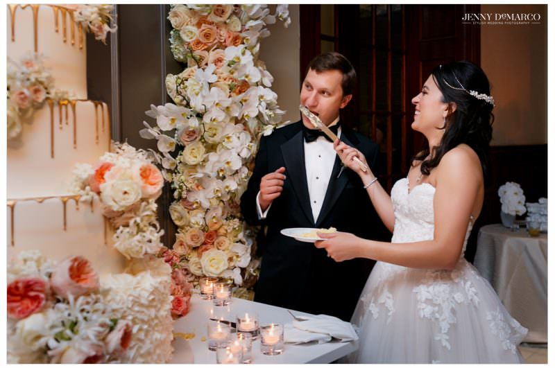 Bride and groom cut their floral wedding cake.