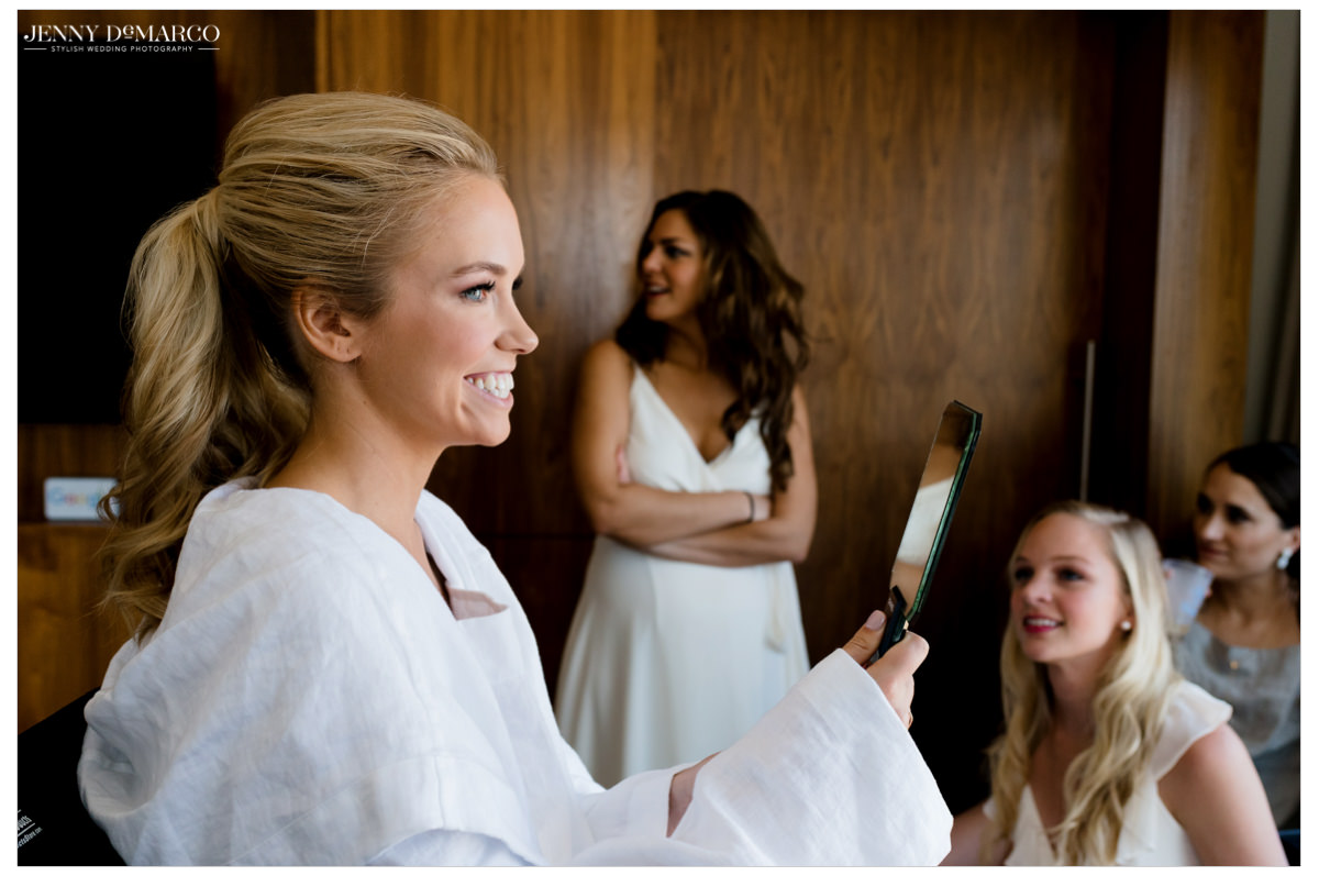Bride looks at herself in the mirror.