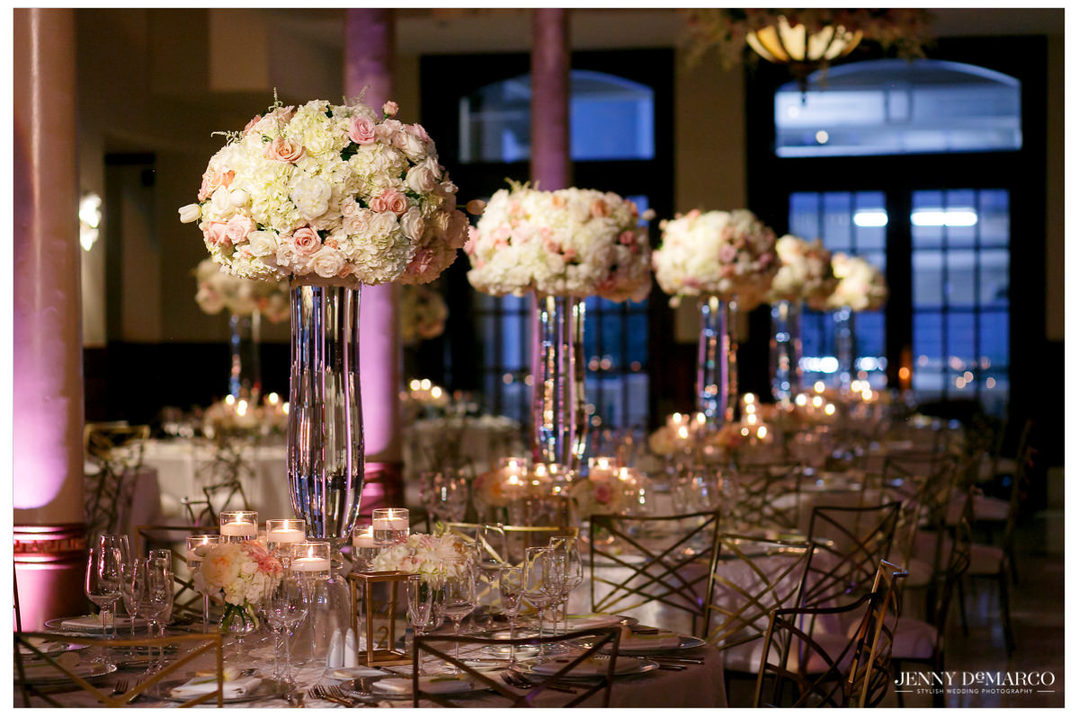 The reception is decorated with white and pink florals and gold accents.