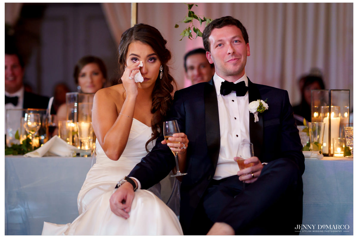 The couple sheds a tear during toasts.