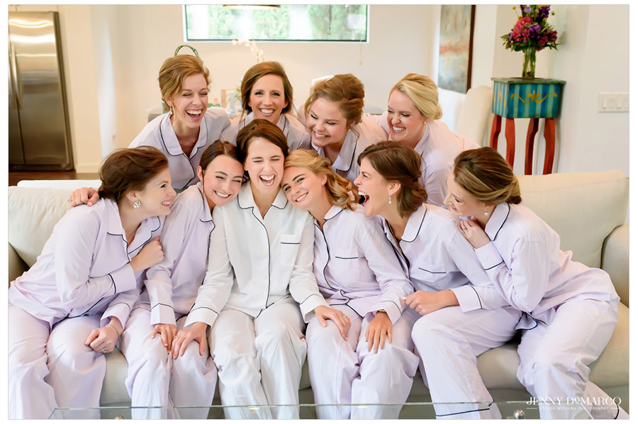 Bride laughing with all of her bridesmaids