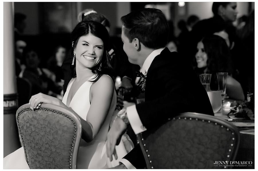 bride and groom smiling at each other 