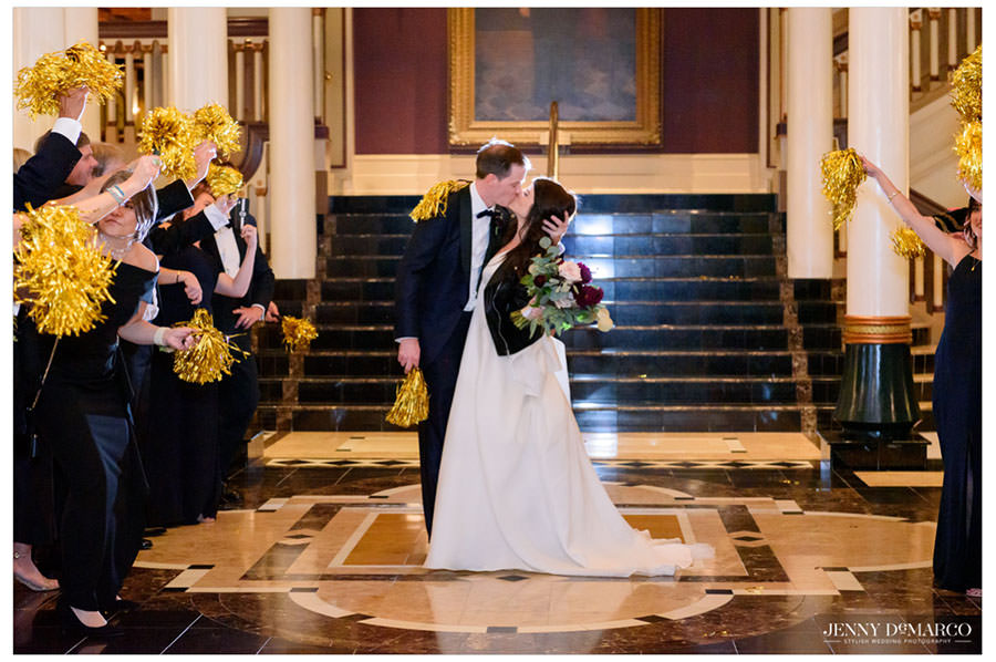 bride and groom kissing during the exit