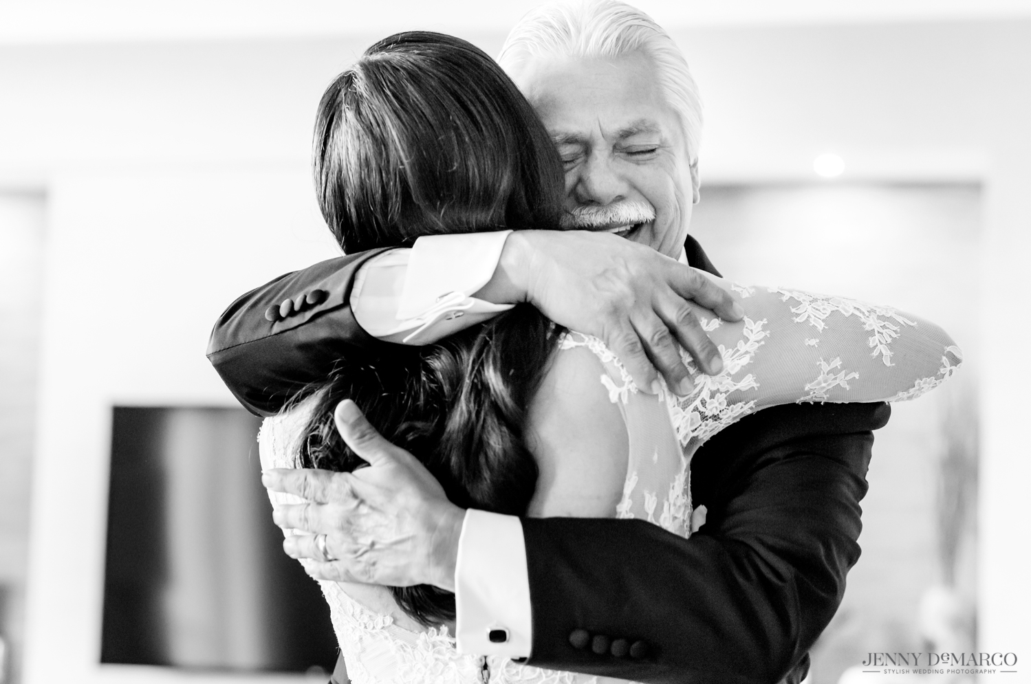 father of the bride hugging the bride