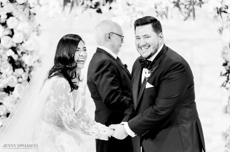 Bride and Groom laughing at the alter