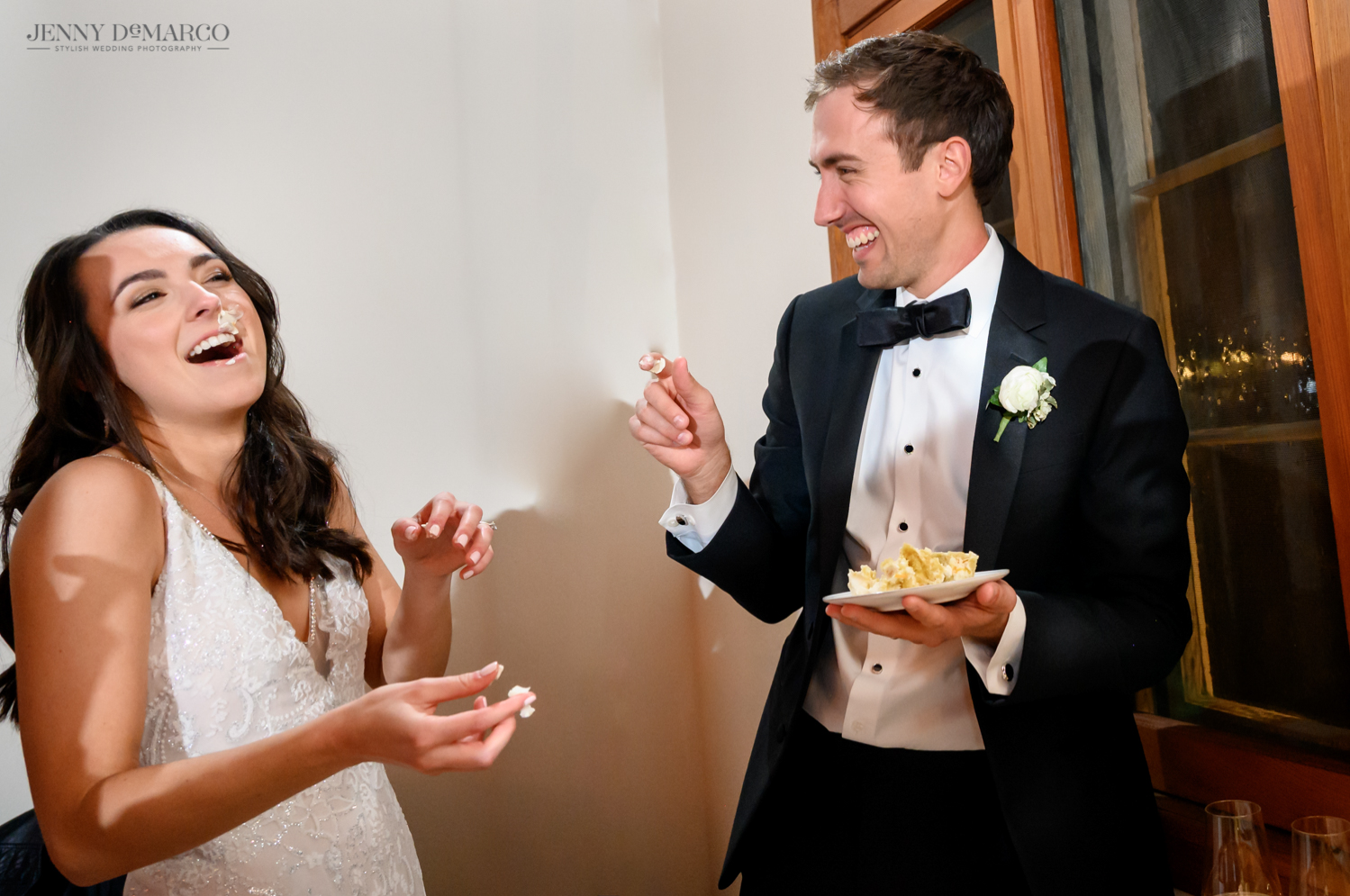 bride and groom feeding each other cake 
