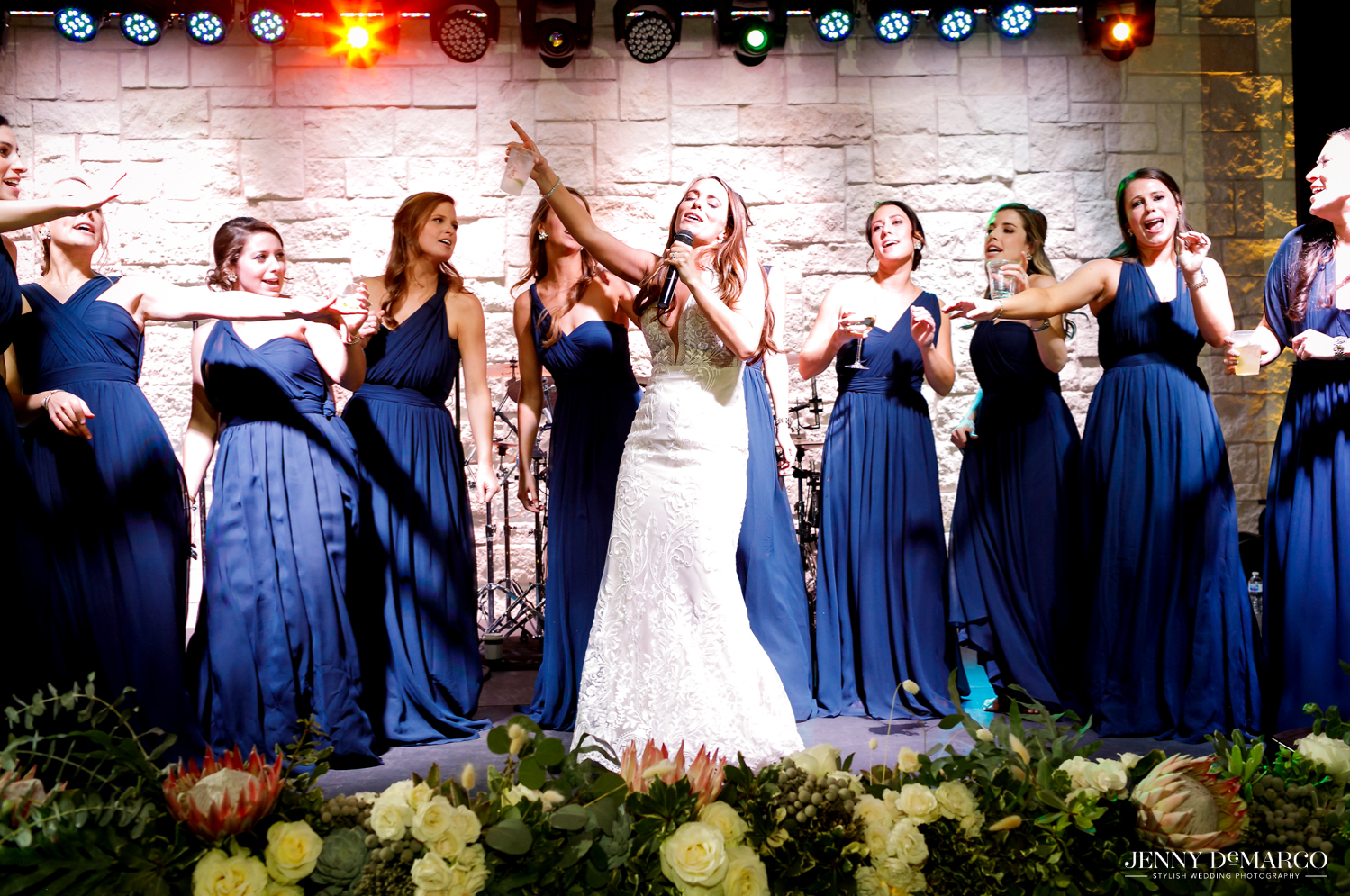 Bride and bridesmaids singing on stage