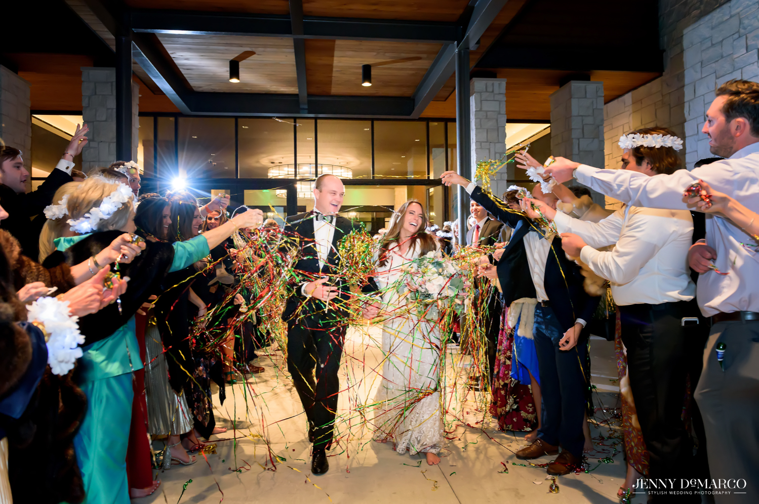 Bride and Groom covered in confetti as they walk out of wedding reception