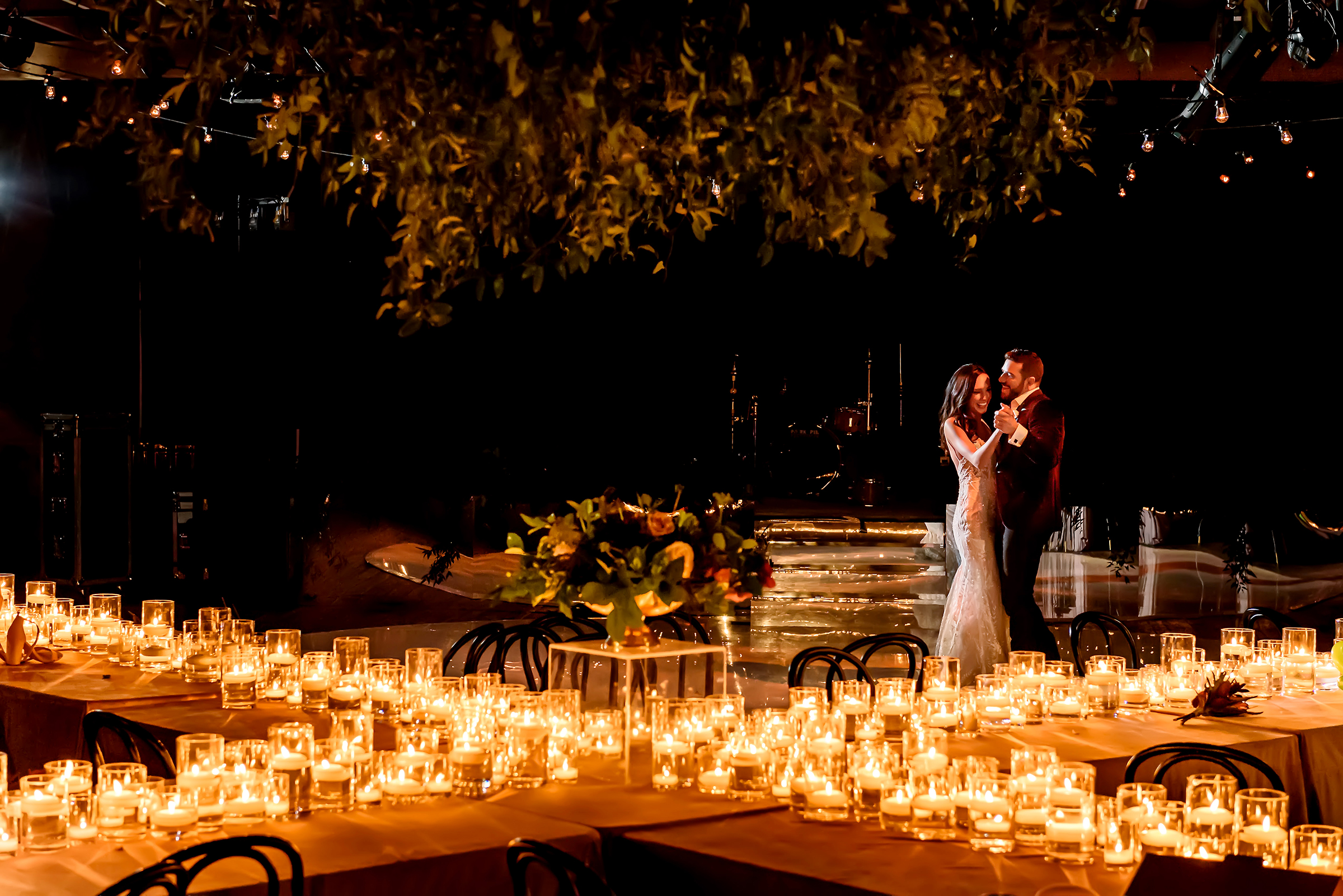 Bride and groom dancing to candlelight