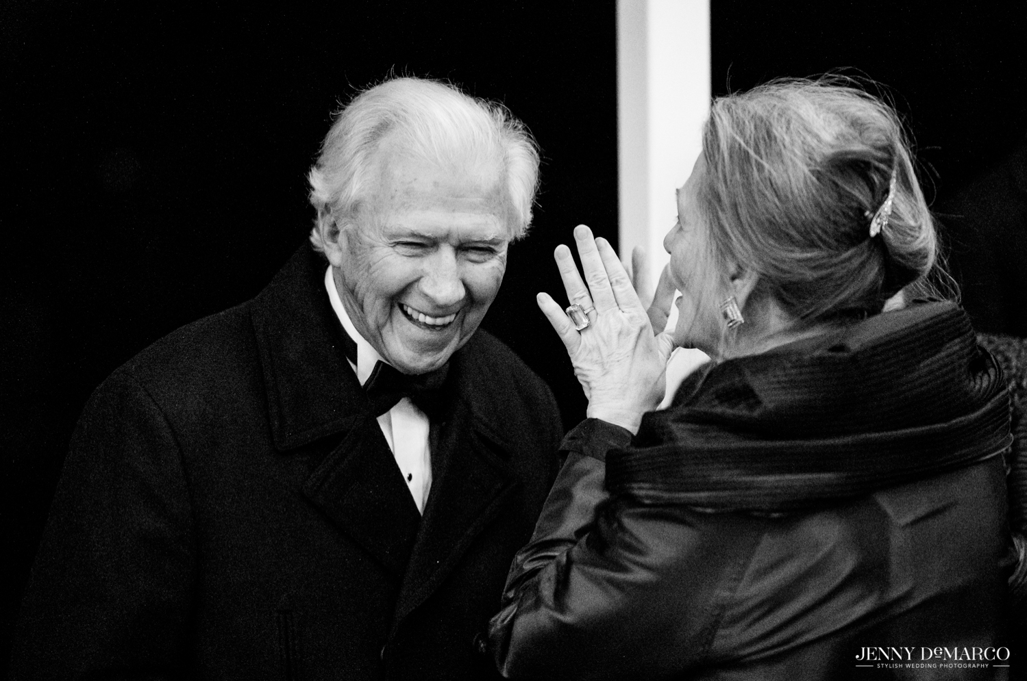 brides parents laughing with each other 