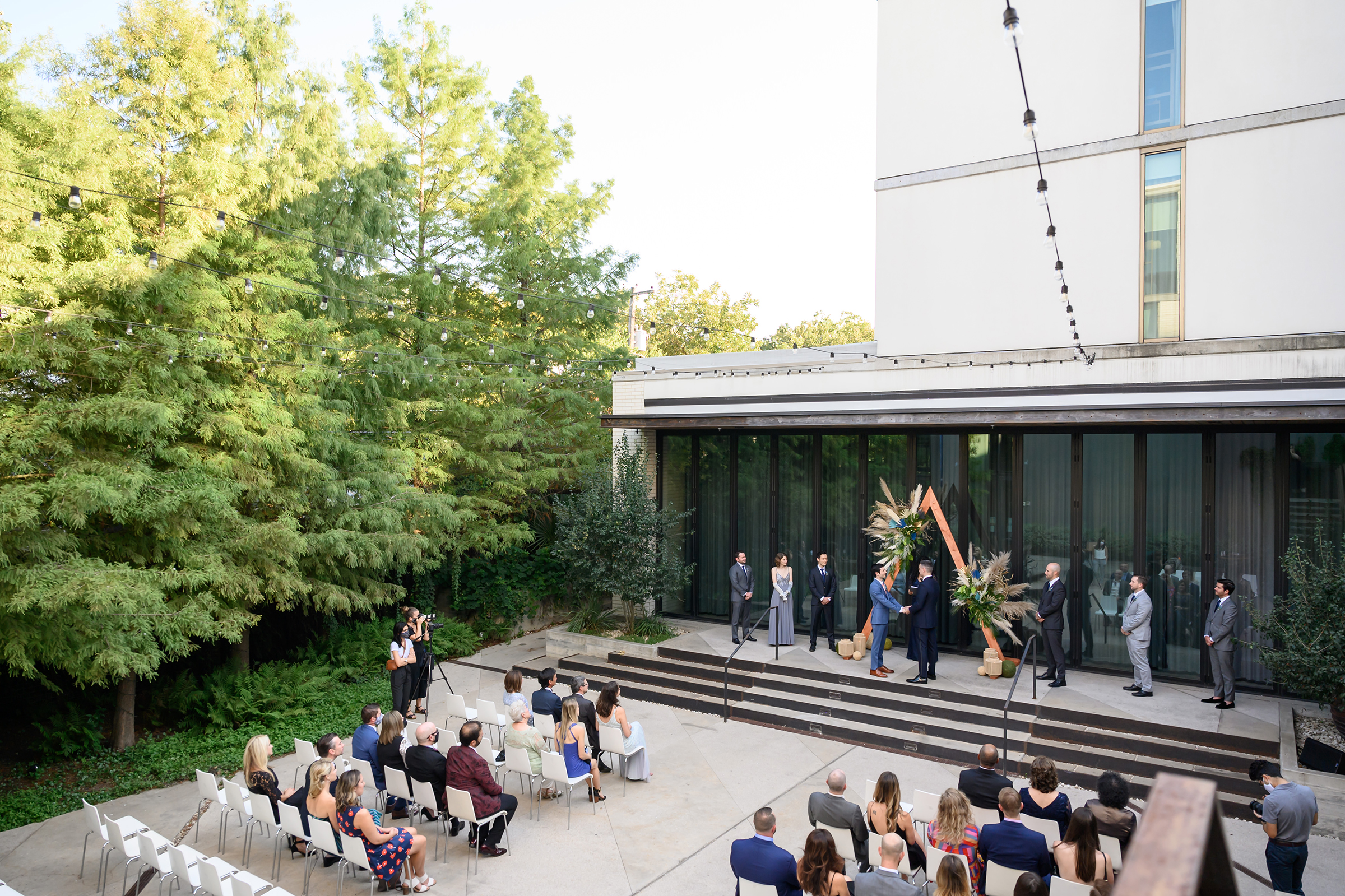 Ceremony venue with guests watching grooms get married