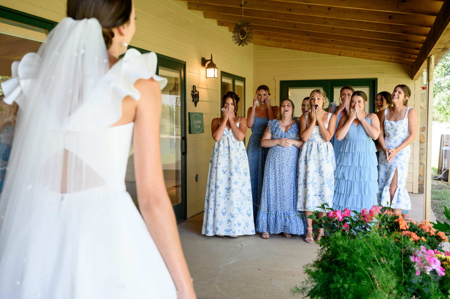bridesmaids getting first look at bride in her wedding dress