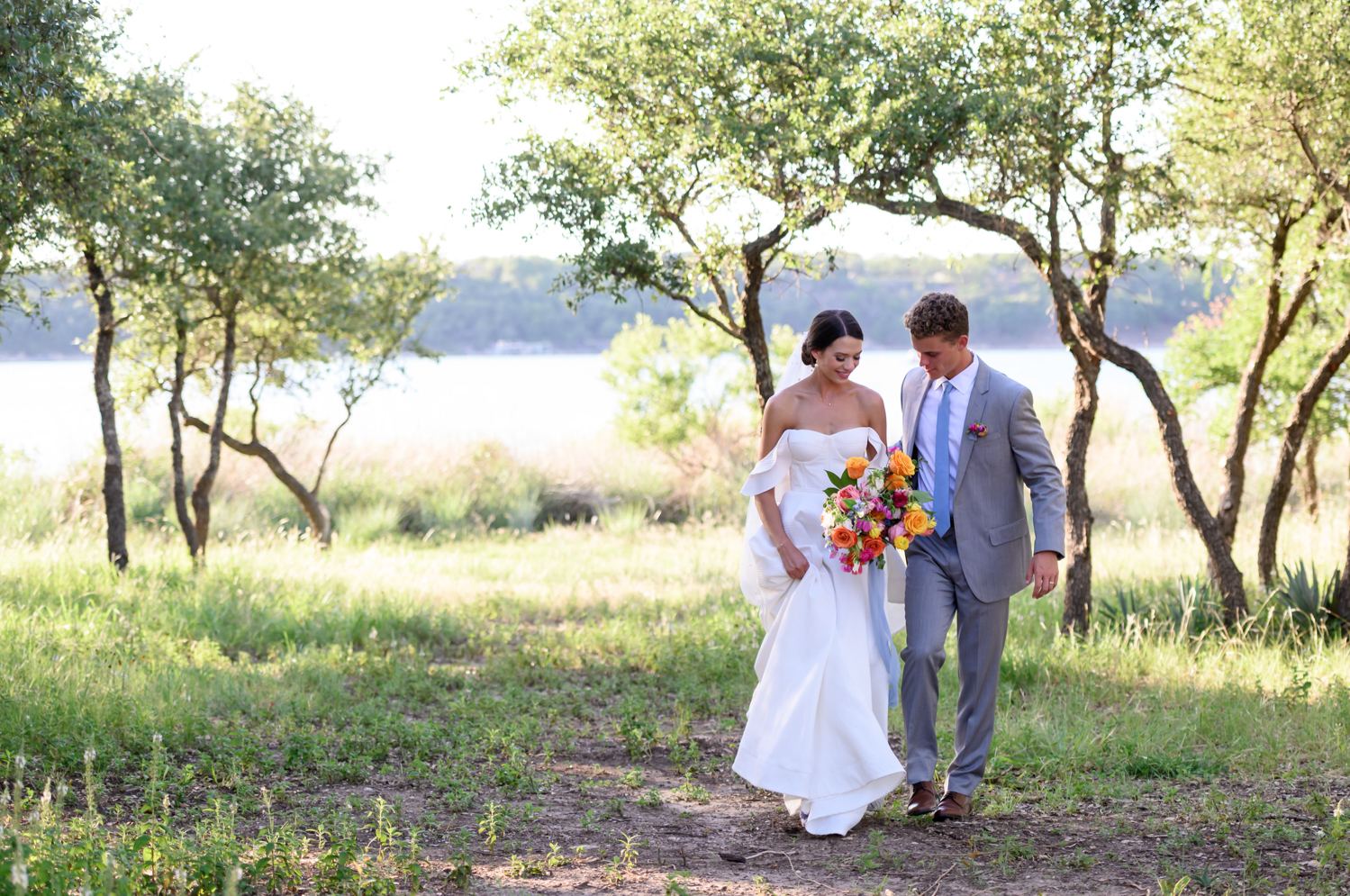 Bride and groom walking with colorful bridal bouquet 