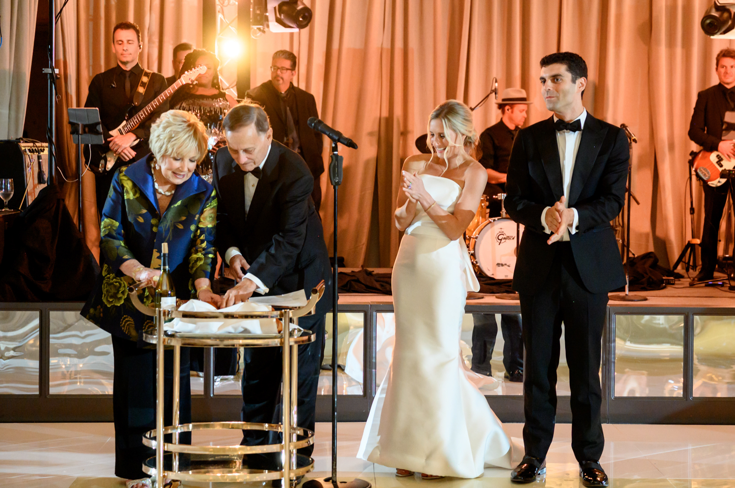 The bride and groom clap as family members present a Jewish wedding tradition